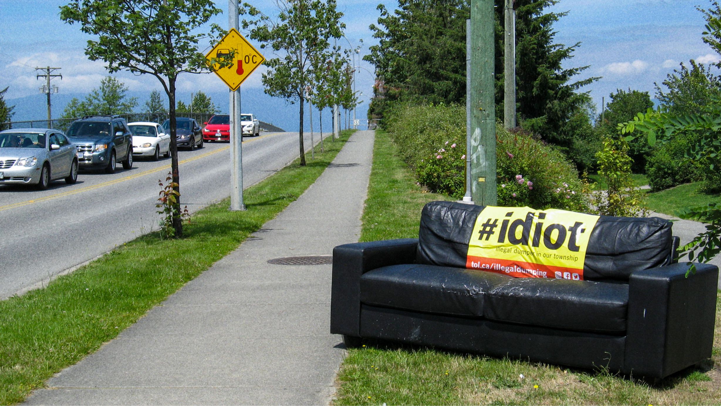 IDIOT: Illegal Dumper in Our Township Sticker on abandonded couch